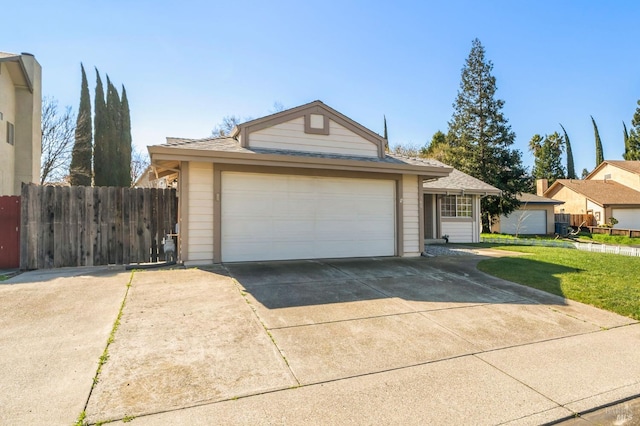 view of front of property featuring a garage, a front yard, concrete driveway, and fence