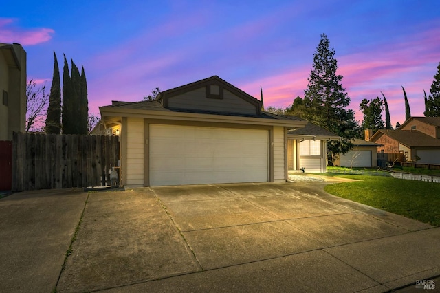 ranch-style house with a garage, concrete driveway, and fence