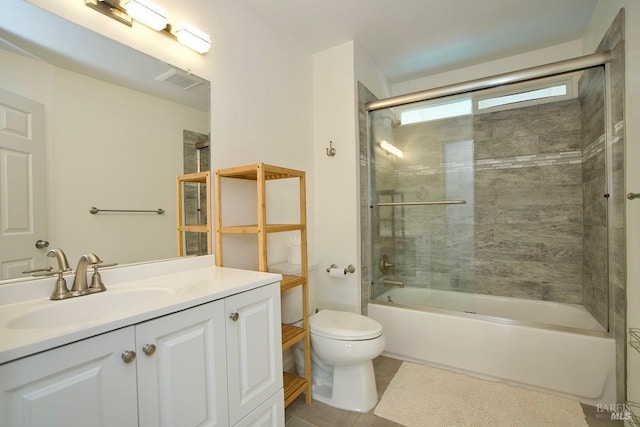 full bath featuring toilet, combined bath / shower with glass door, and vanity