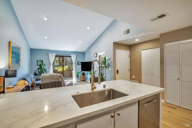 kitchen with open floor plan, a sink, and visible vents