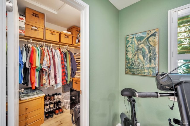 walk in closet with wood finished floors