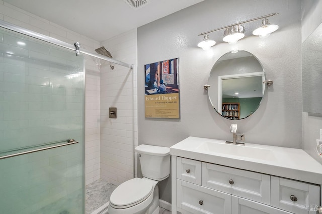 bathroom featuring a stall shower, vanity, and toilet