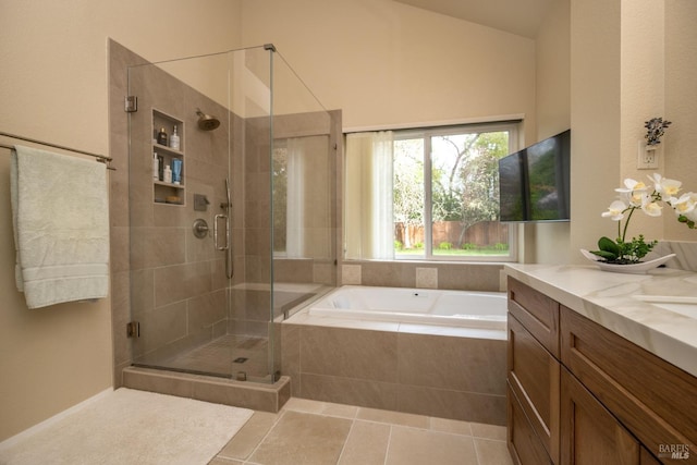 bathroom with vanity, a shower stall, a bath, and tile patterned floors