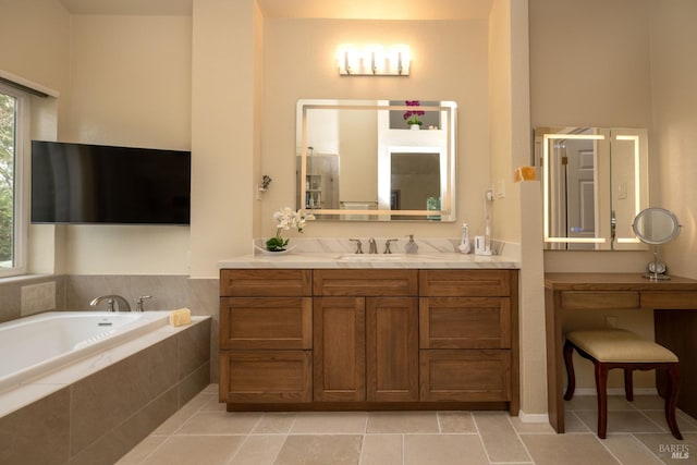 bathroom with tile patterned flooring, a bath, and vanity