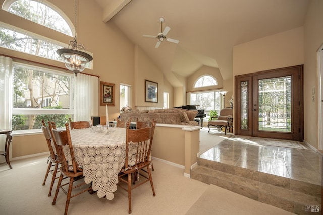 dining space with baseboards, high vaulted ceiling, beamed ceiling, and ceiling fan with notable chandelier