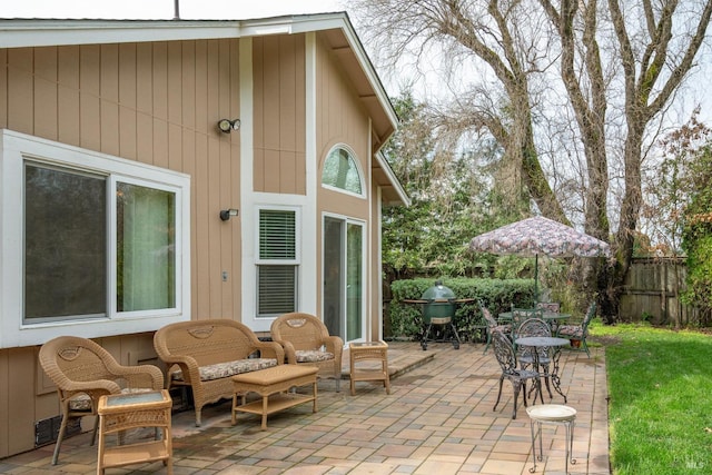 view of patio / terrace with a grill and fence