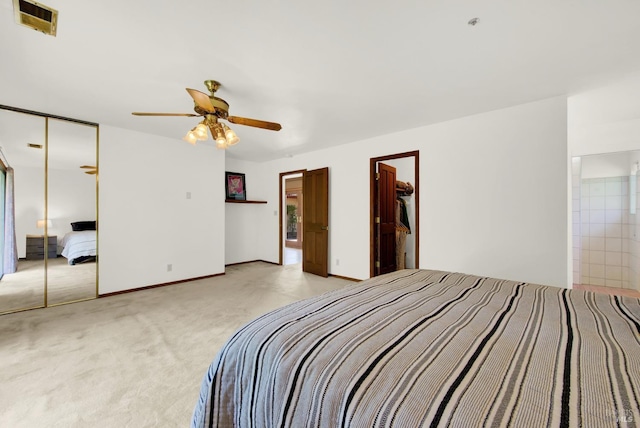 bedroom featuring ceiling fan, light carpet, visible vents, baseboards, and a closet