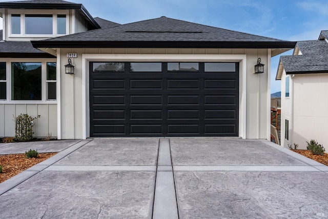 garage featuring concrete driveway