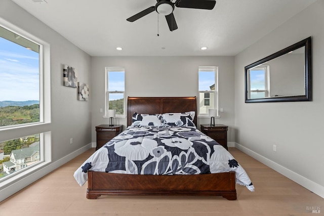 bedroom with recessed lighting, light wood-style flooring, and baseboards