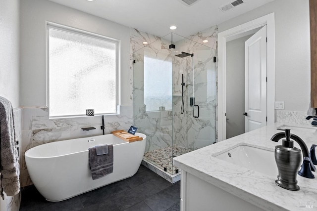 full bath with vanity, visible vents, tile walls, a soaking tub, and a marble finish shower