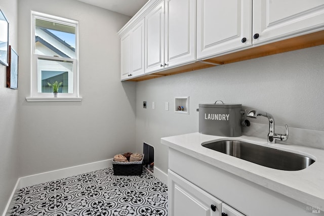 clothes washing area featuring hookup for a washing machine, hookup for an electric dryer, a sink, baseboards, and cabinet space