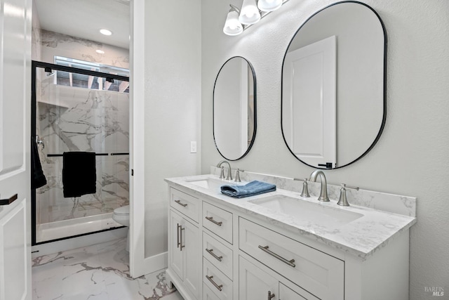 full bathroom featuring marble finish floor, double vanity, a sink, and a marble finish shower