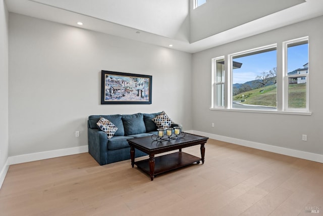 living area with light wood finished floors, recessed lighting, and baseboards