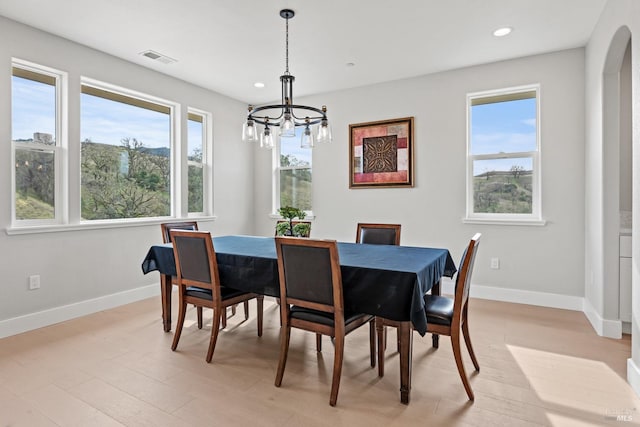 dining room with baseboards, visible vents, arched walkways, and recessed lighting