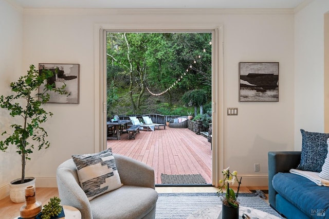 interior space with crown molding, baseboards, and wood finished floors