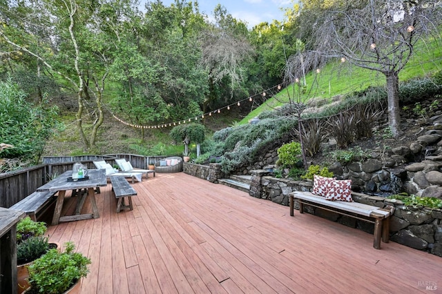 wooden terrace featuring outdoor dining space