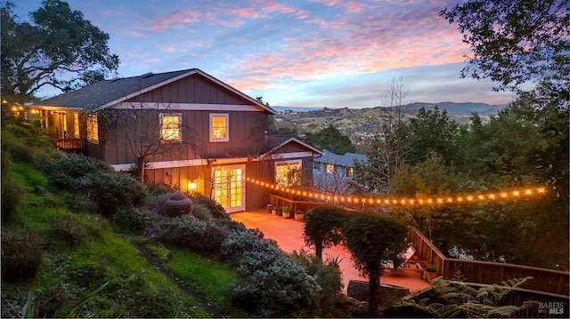 rear view of property with french doors and a mountain view