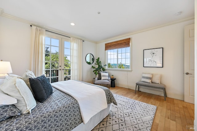 bedroom with light wood-style flooring, access to outside, crown molding, and french doors