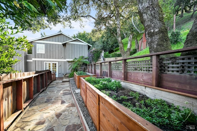 surrounding community featuring a garden and fence