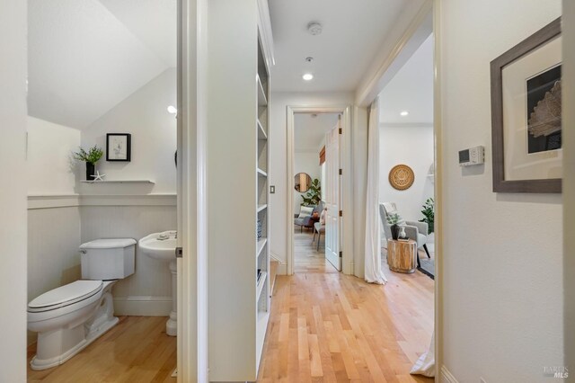 hallway with light wood-style floors and baseboards