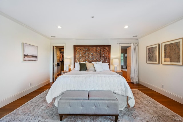 bedroom featuring crown molding, baseboards, and wood finished floors