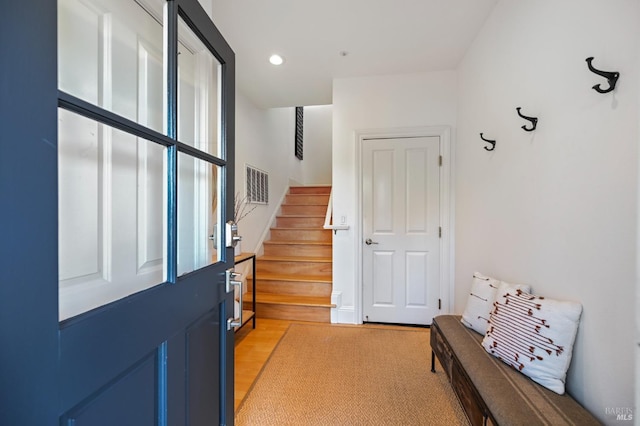 doorway to outside with recessed lighting, visible vents, and stairs