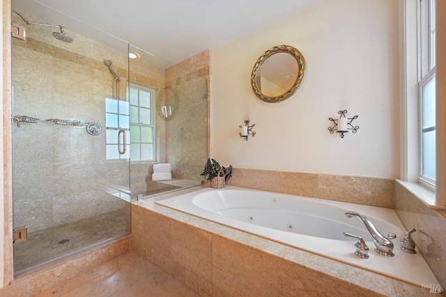 full bath featuring a healthy amount of sunlight, a shower stall, and a tub with jets