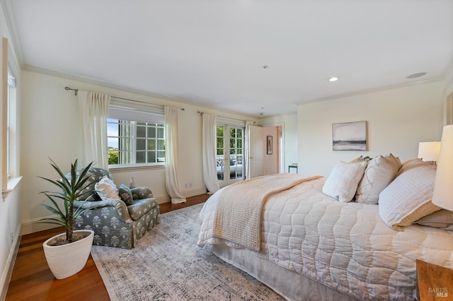 bedroom featuring baseboards, wood finished floors, crown molding, french doors, and recessed lighting