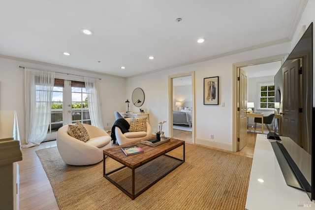 living room featuring baseboards, french doors, ornamental molding, and recessed lighting