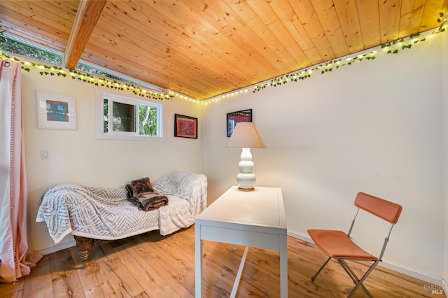 living area featuring hardwood / wood-style floors, wooden ceiling, and baseboards