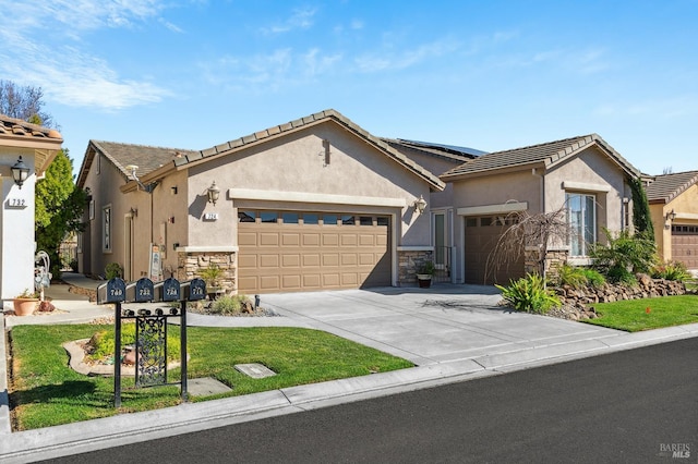 view of front of home featuring a garage, stone siding, concrete driveway, and stucco siding