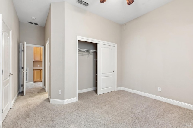 unfurnished bedroom with baseboards, visible vents, and light colored carpet