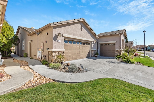 view of front facade with stucco siding, an attached garage, stone siding, driveway, and a front lawn