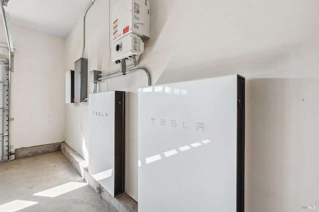 utility room with a garage and water heater