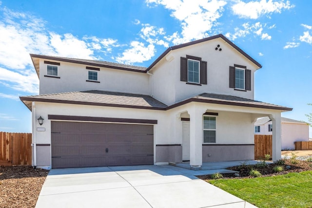 view of front of house with concrete driveway, an attached garage, fence, and stucco siding