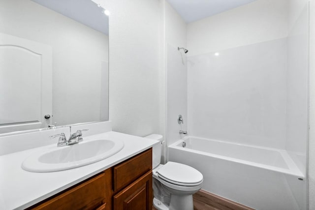bathroom with toilet, shower / bathing tub combination, vanity, and wood finished floors