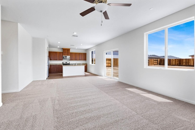 unfurnished living room with baseboards, light carpet, recessed lighting, visible vents, and ceiling fan