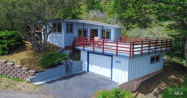 view of front facade featuring a garage and a deck