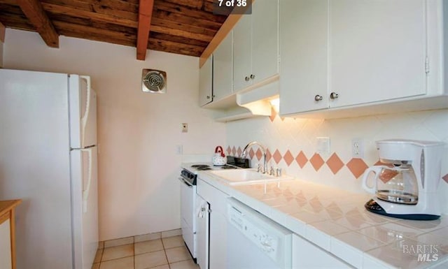 kitchen with tile counters, white appliances, white cabinets, and wooden ceiling