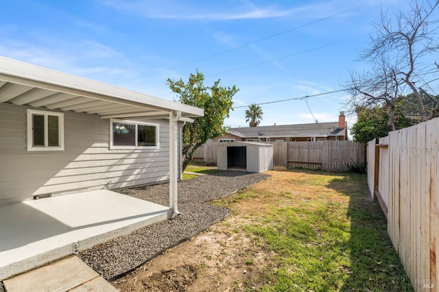 view of yard featuring a patio area, a shed, an outdoor structure, and a fenced backyard