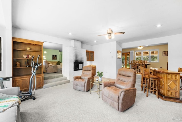 living room featuring carpet, ceiling fan, a fireplace, and recessed lighting