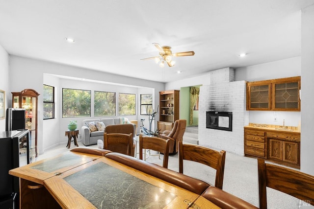 dining area with ceiling fan, a fireplace, carpet flooring, and recessed lighting