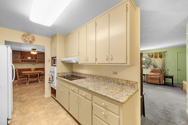 kitchen featuring light countertops, white appliances, cream cabinetry, and under cabinet range hood