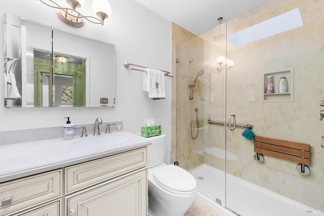 bathroom featuring vanity, a shower stall, toilet, and an inviting chandelier