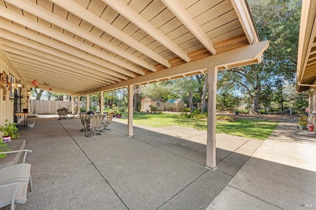 view of patio featuring outdoor dining area and fence