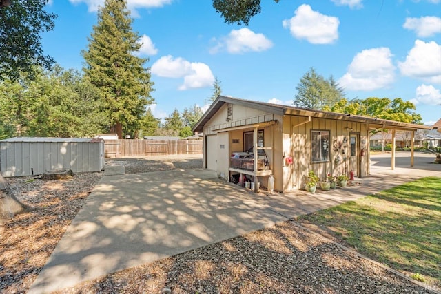 view of outbuilding with fence and an outdoor structure