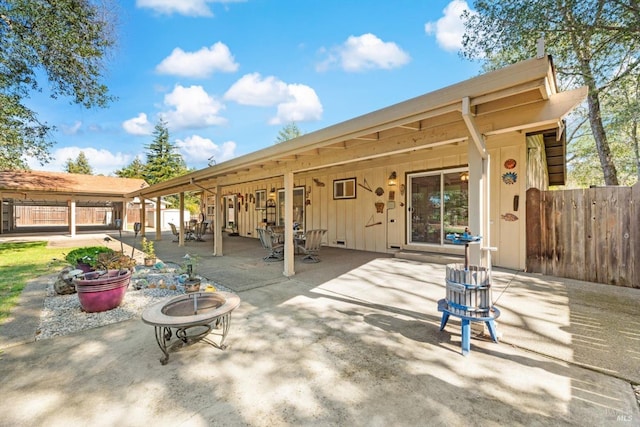 view of patio / terrace featuring an outdoor fire pit and fence