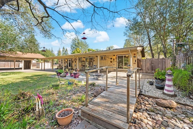 back of house featuring a yard, a patio, and fence