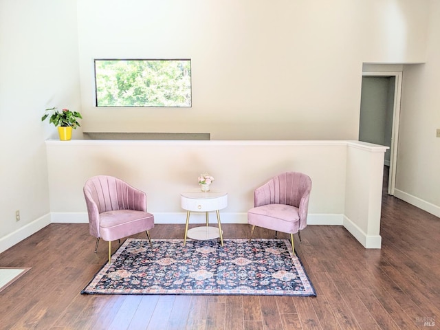 living area featuring baseboards and wood finished floors