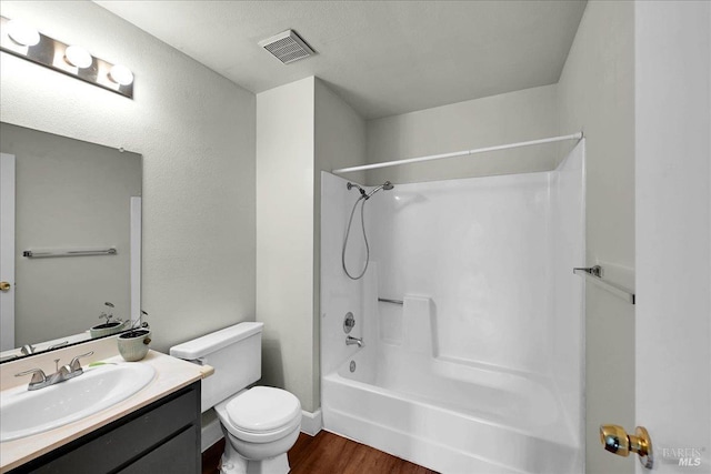 bathroom with shower / bathtub combination, vanity, visible vents, toilet, and wood finished floors